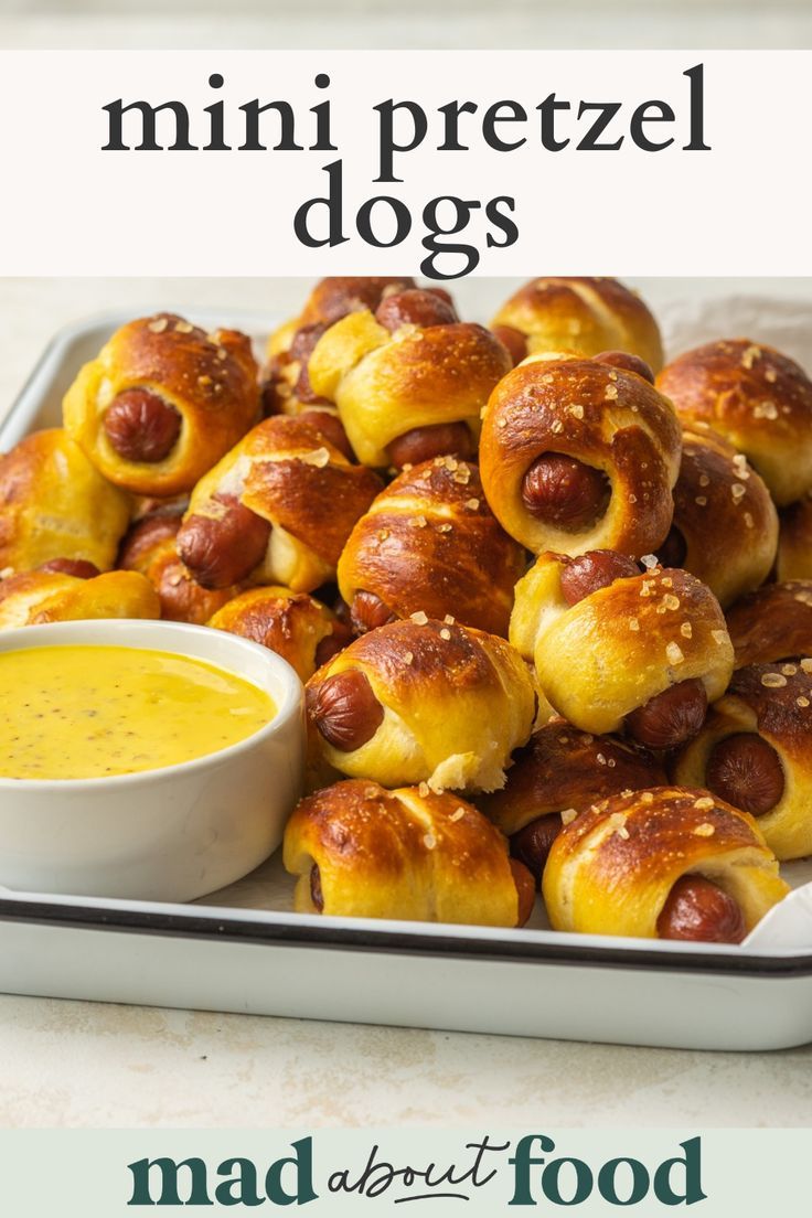 mini pretzel dogs on a plate with dipping sauce