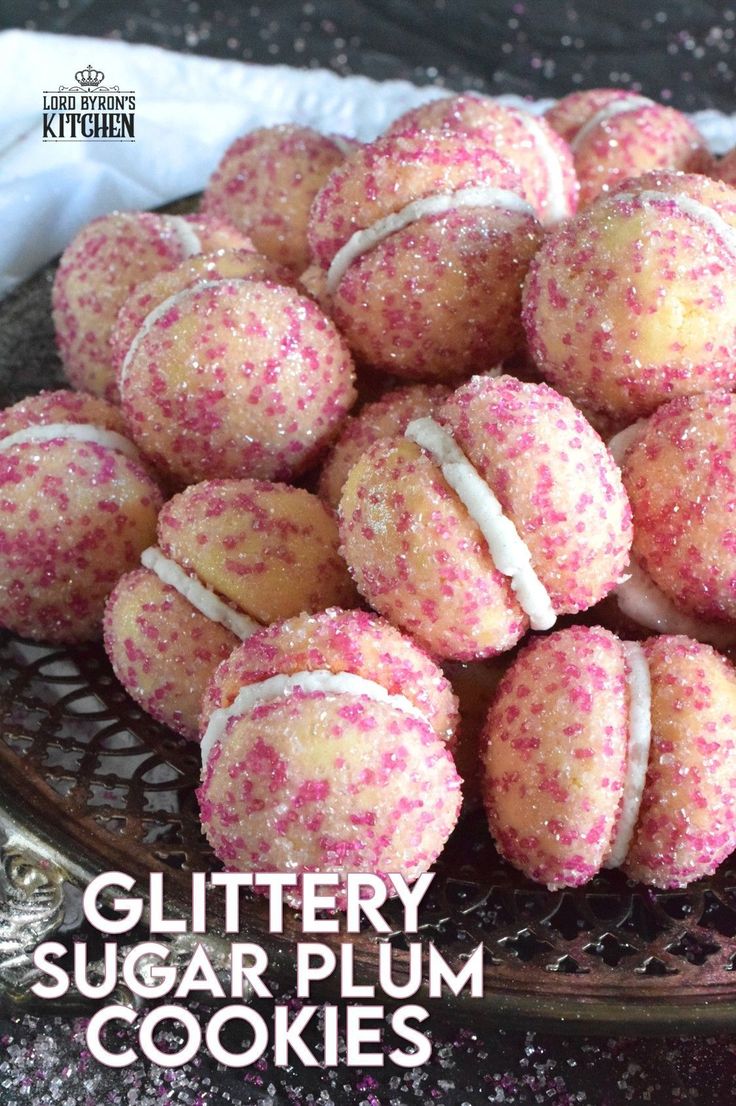 a plate full of sugar plum cookies with sprinkles on top and the words glittery sugar plum cookies above it