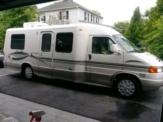 an rv is parked in front of a house