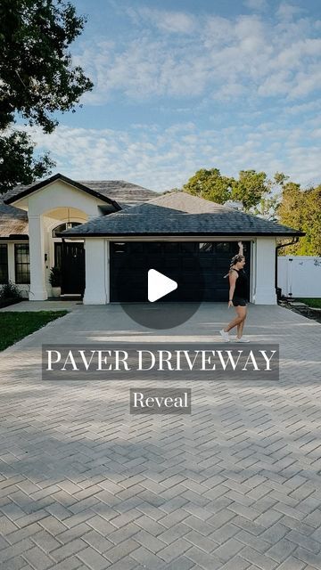 a woman walking across a driveway in front of a house with the words paver driveway reveal