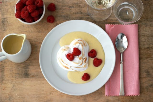 a plate topped with dessert on top of a table next to cups and spoons