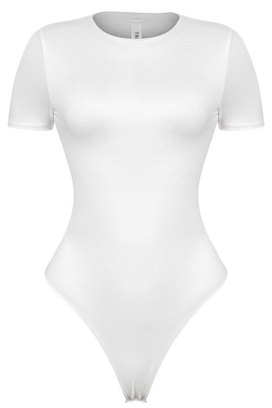 Look and feel your best in the Mya Bodysuit. This essential bodysuit features ultra-soft, smooth fabric and a snap button closure for a comfortable fit. The classic white color offers versatile styling for any occasion. Mya Bodysuit Features: Short Sleeve Bodysuit - thong back Snap Button Closure Ultra soft material True to size - very stretchy 96% Polyester 4% Spandes White Bodysuit Short Sleeve, Cute Body Suits, White Tops For Girls, White Bodysuit Outfit, White Shirt Bodysuit, Wishlist Clothes, White Body Suit, Casual Brunch Outfit, White Long Sleeve Bodysuit