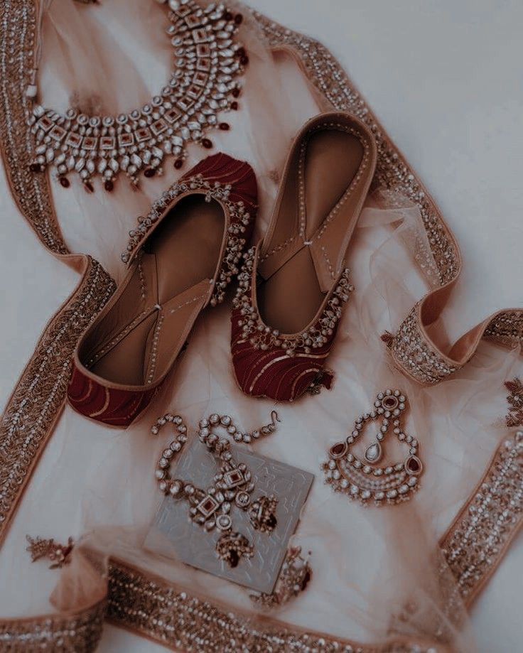 a pair of red shoes sitting on top of a white floor next to a purse