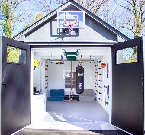 the inside of a small house with a basketball hoop and gym equipment on the wall