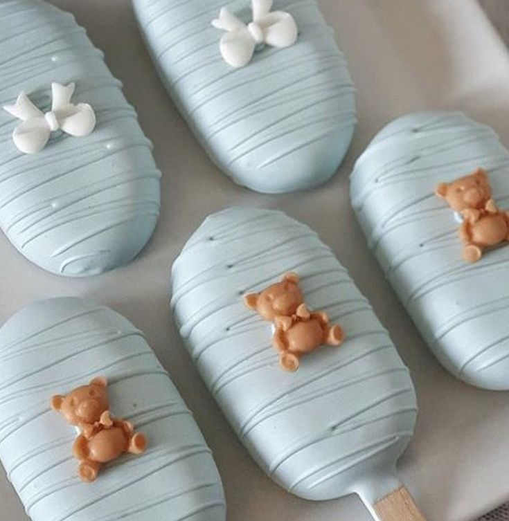 there are four cookies shaped to look like baby's cribs with teddy bears on them