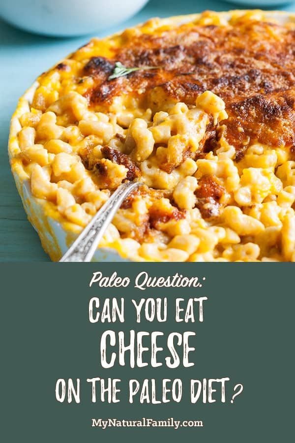 a plate filled with macaroni and cheese on top of a blue table