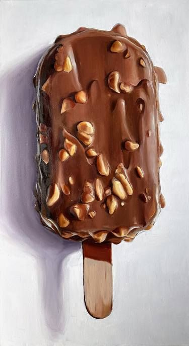 an ice cream covered in nuts on top of a wooden stick with a white wall behind it