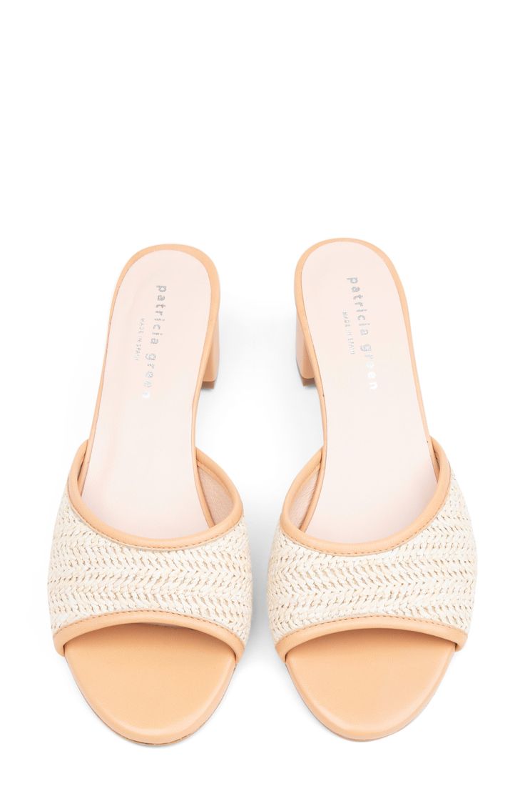 Woven raffia and smooth leather create textural intrigue on a weekend-ready slide sandal set on a cushioned footbed and wrapped block heel. 2" heel Cushioned footbed Synthetic and leather upper/leather lining/synthetic sole Made in Spain Summer Block Heel Mules In Natural Color, Spring Natural Open Heel Mules, Straw Sandals With Removable Insole And Block Heel, Natural Straw Sandals With Stacked Heel, Spring Low Heel With Woven Sole, Spring Straw Mules, Chic Straw Sandals With Cushioned Footbed, Spring Sandals With Stacked Heel In Natural Color, Straw Sandals With Block Heel In Natural Color