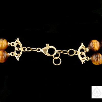 Description: This exquisite necklace is a stunning combination of Tiger eye, Ivory Netsuke Beads, and Amber with 14K Gold Findings. The necklace weighs 291.3 grams and features a variety of beads, each with its unique pattern and color. The 14K yellow gold findings add a touch of elegance and luxury to this beautiful piece of jewelry. Specifications: Bead Type: Tigereye, Ivory Netsuki Beads, Amber Metal: 14K Yellow Gold Weight: 291.3 grams Necklace Length: N/A Clasp Type: 14K Yellow Gold Item Co Elegant Rondelle Beads With Natural Stones, Elegant Round Spacer Beads, Amber Round Beads Jewelry For Formal Occasions, Luxury Handmade Double Strand Necklace, Formal Amber Jewelry With Round Beads, Gold Double Strand Hand-strung Jewelry, Gold Double Strand Hand-strung Necklace, Classic Double Strand Beaded Necklaces, Luxury Beads, Gems, And Cabochons For Formal Occasions