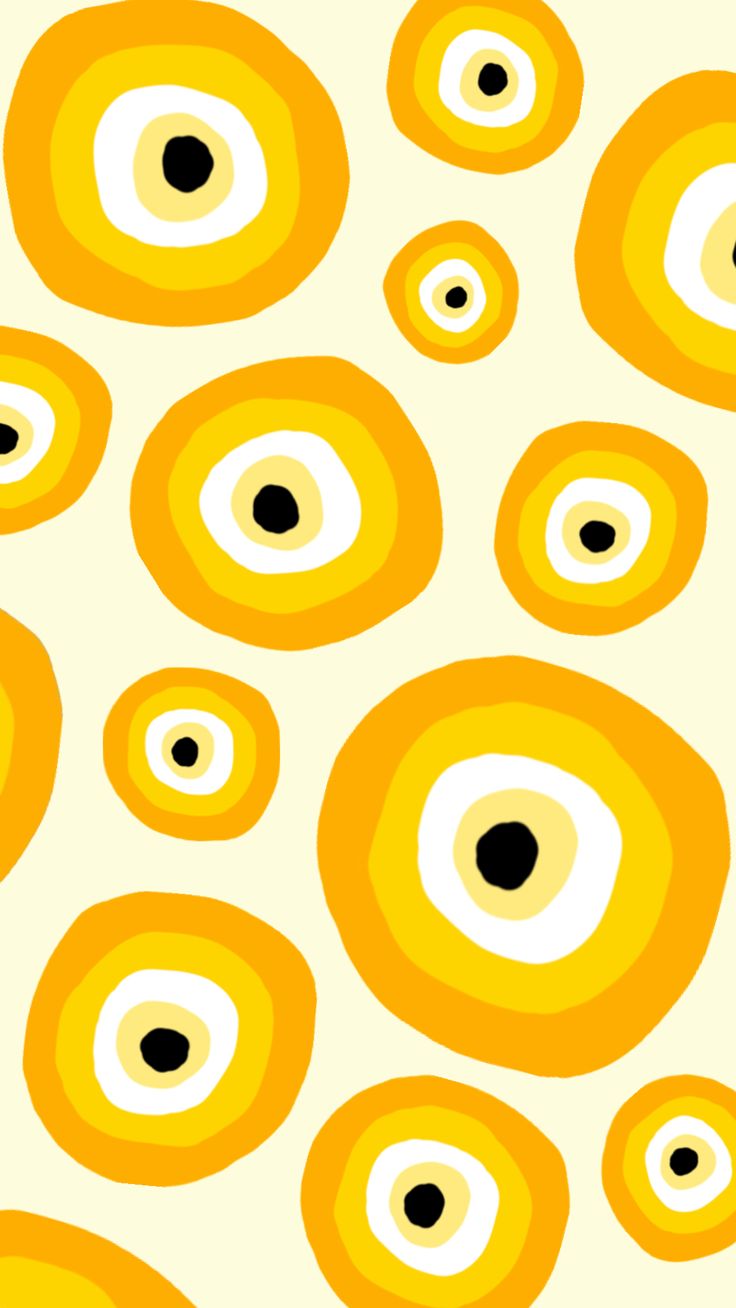 an orange and white pattern with black dots on the bottom half of each eyeball