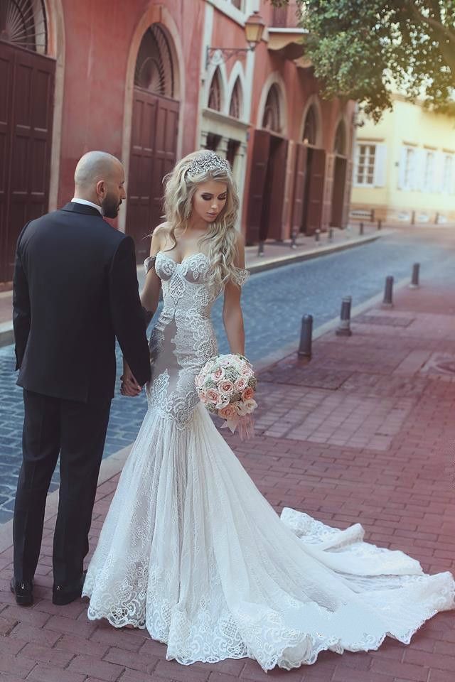 the bride and groom are walking down the street