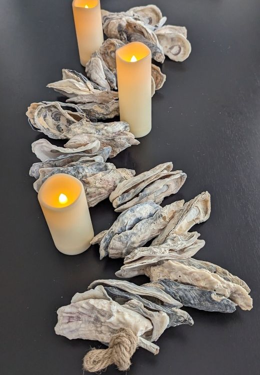 three candles sitting on top of some driftwood