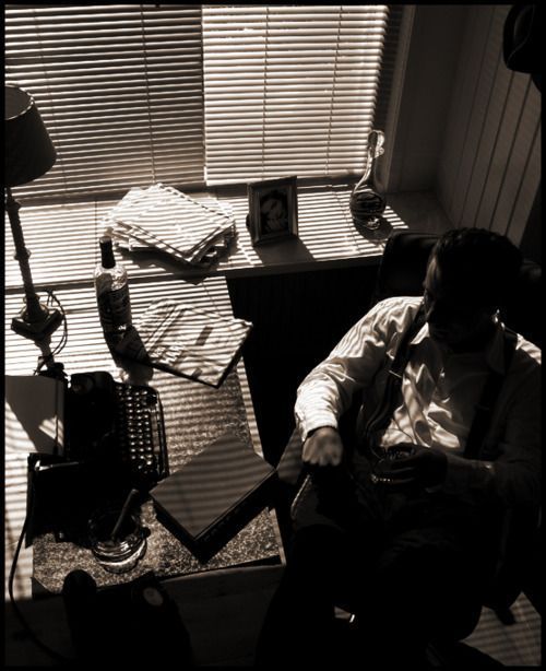 a man sitting in a chair next to a window