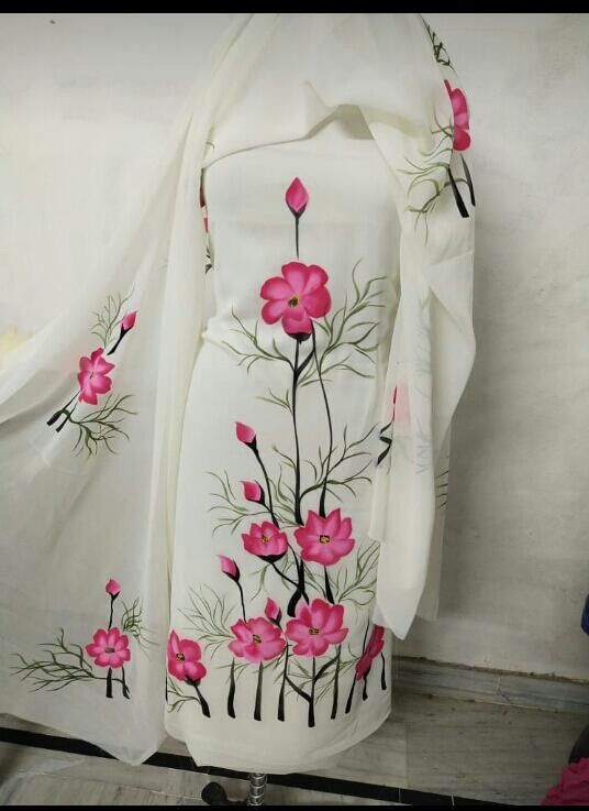 a white dress with pink flowers painted on it