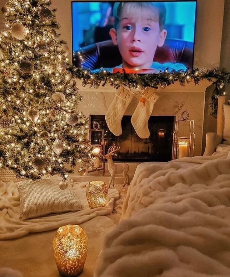 a living room with a christmas tree in the corner and a flat screen tv on