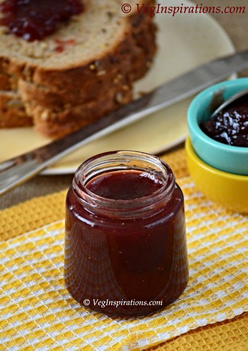 a jar of jam next to slices of bread