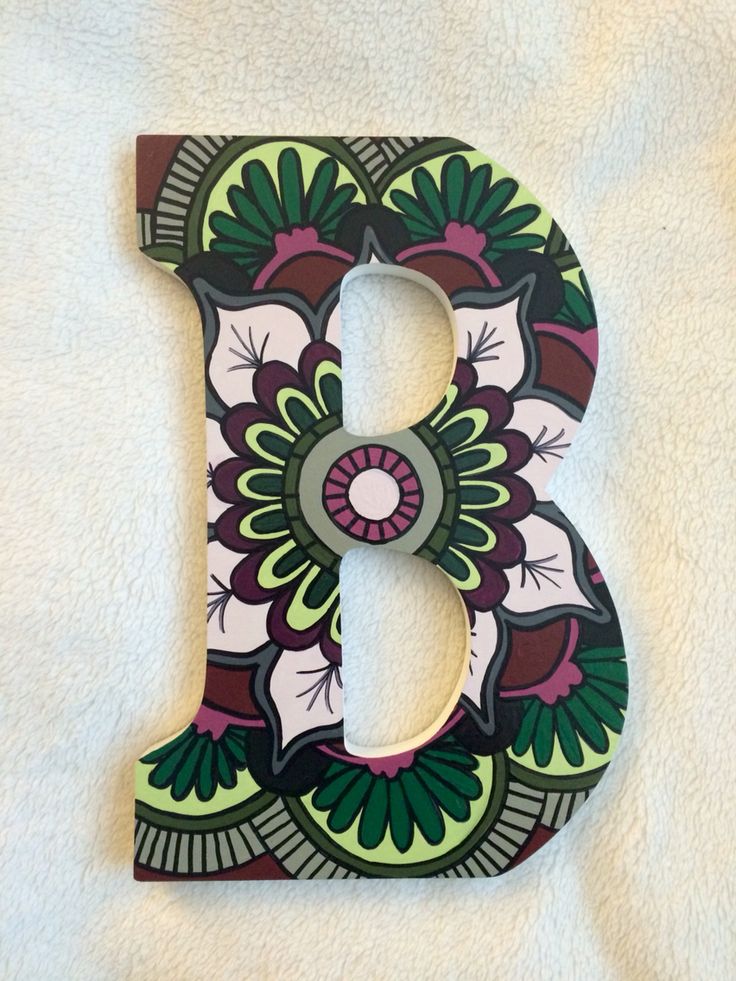 the letter b is decorated with flowers and leaves on it's side, along with a white background