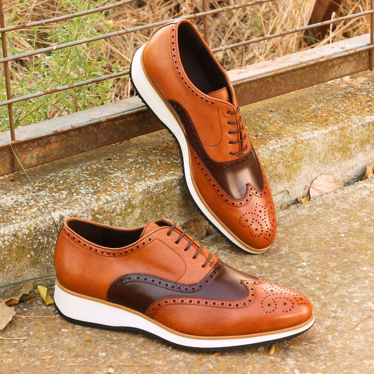 Also known as a wingtip, the Full Brogue is easily identifiable as one of the most classic pairs of men's dress shoes on the market. Featuring a brogue pattern along the sides as well as the toe cap, every man needs a Full Brogue in his shoe closet. The Details: Materials: med brown polished calf + cognac painted full grain Lining: brown calf leather Sole: Running Sole Last: Zurigo - Rounded toe for fraditional English Look The Fine Print: Shoe production timeline/shipping can vary from 15-30 da Brown Wingtip Leather Derby Shoes, Brown Wingtip Dress Shoes With Rubber Sole, Brown Wingtip Dress Shoes With Leather Sole, Brown Wingtip Lace-up Shoes For Semi-formal Occasions, Brown Leather Wingtip Shoes With Goodyear Welt, Brown Goodyear Welted Leather Wingtip Shoes, Brown Goodyear Welted Wingtip Dress Shoes, Masculine Leather Wingtip Shoes With Brogue Detailing, Masculine Wingtip Leather Shoes With Brogue Detailing