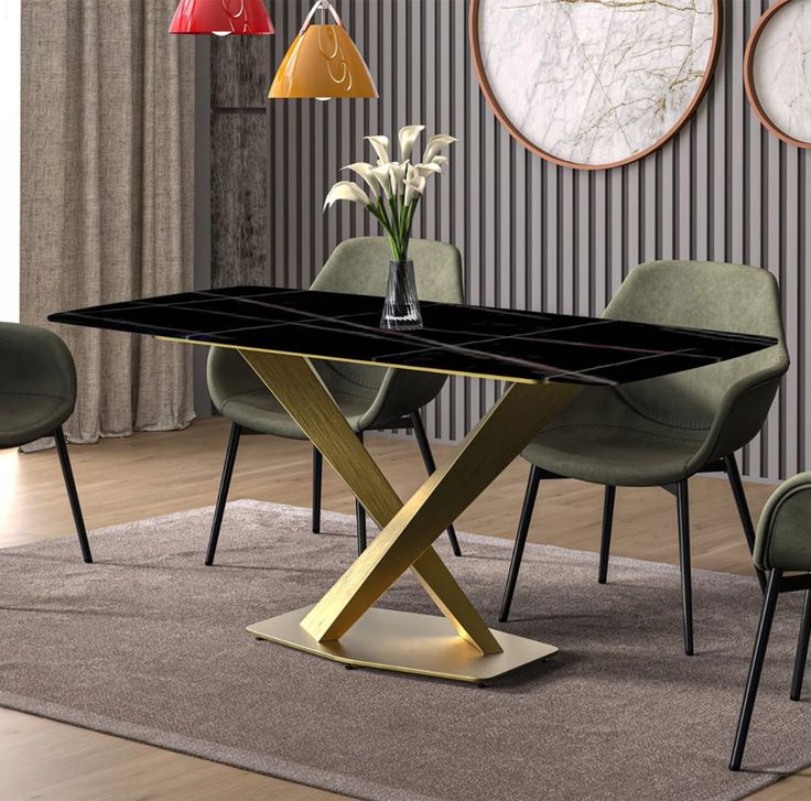 a modern dining table with black marble top and gold cross legs, surrounded by green chairs