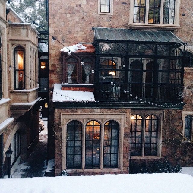 an old building with lots of windows in the snow