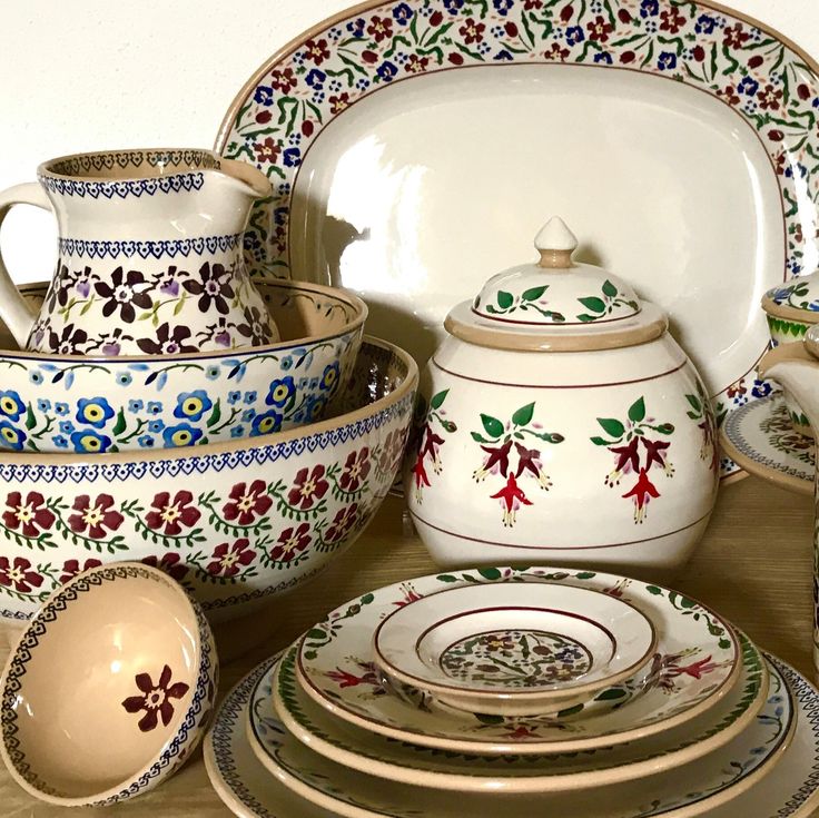 a table topped with lots of different types of dishes and bowls next to each other