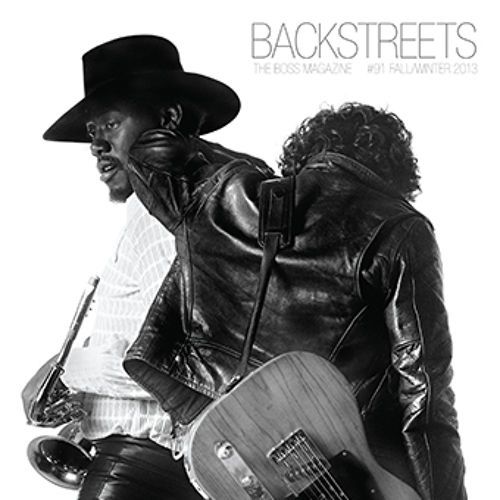 two men in leather jackets and hats are holding guitars together, one man is wearing a black hat