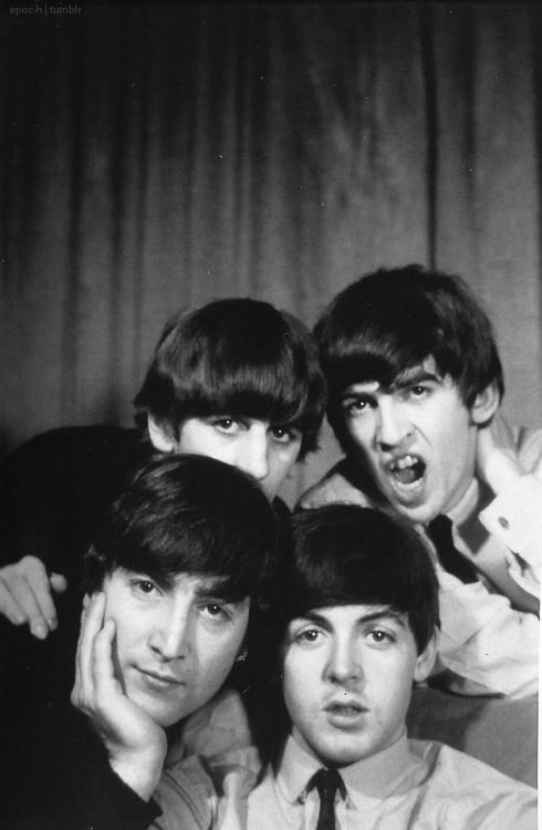 the beatles posing for a black and white photo