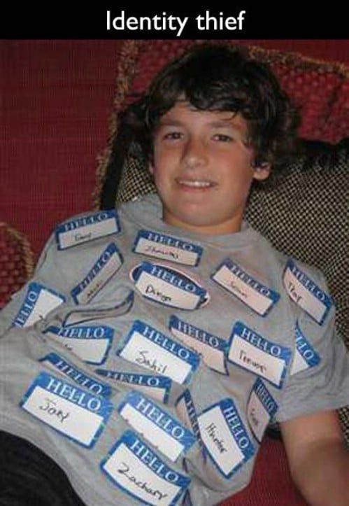 a young boy sitting on top of a couch wearing a shirt that says identity thief