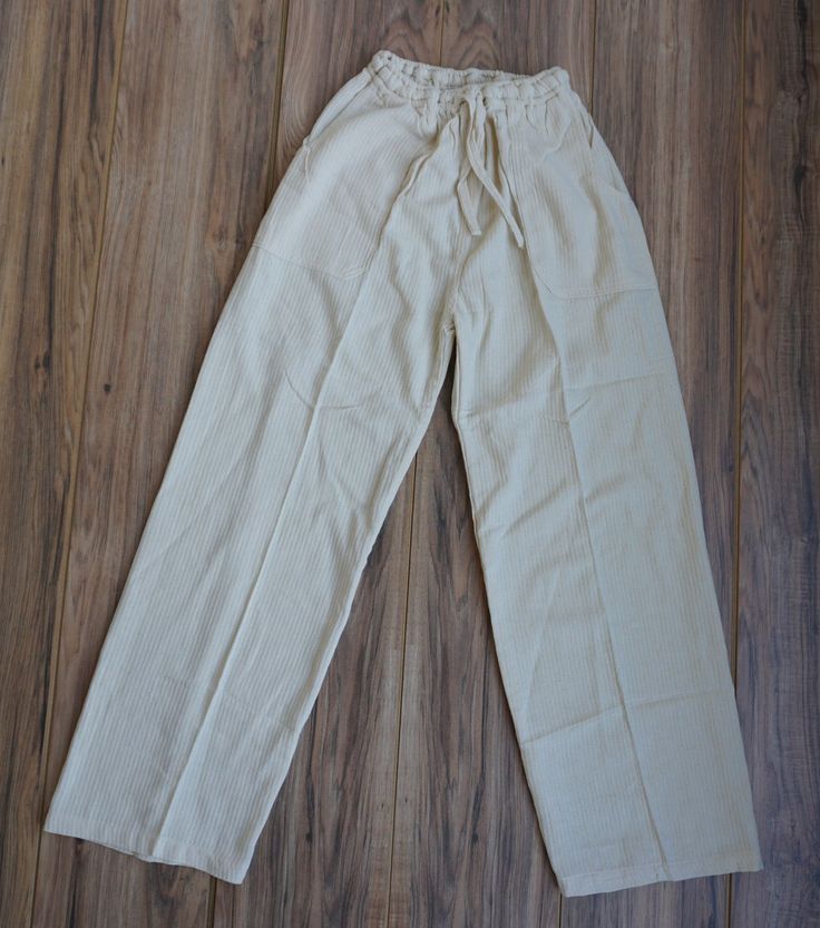 Look fashionable and feel comfortable in these XL beige woven Boho pants. A perfect blend of style and comfort, these pants feature tribal patterns with an adjustable leg and waist to ensure the perfect fit. These hippie pants are lightweight and breathable, making them ideal for summer days. It has 2 pockets in the front and 1 pocket in the back.Materials:100% Cotton Measurements:Waist circumference: 28" stretches up to 38"Hip circumference: 48"Rise: 13"Inseam: 30"Total Length: 44"Thigh: 12"Leg Hippie Pants, Boho Pants, Adjustable Legs, Waist Circumference, Summer Days, Effortless Style, Perfect Fit, Relaxed Fit, Pants