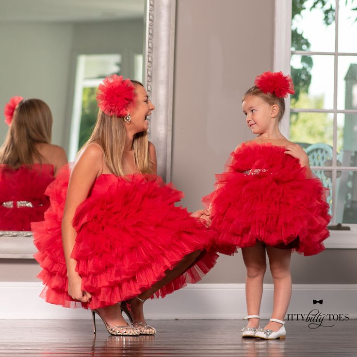 The Isabela dress in red will give your little princess a doll-like look. It is cute, yet very comfortable with a layer of lining inside. It is a ruffled dress with an illusion neckline, layered tulle, and a sparkly silver belt make for the prettiest birthday outfit for little girls. While this one is our top pick for birthday celebrations, she can also wear it to a weddings, tea parties, themed parties, or pageant shows. This dress is also available in pink. Moms can match with her daughter in Red Tulle Dress, Gown Birthday, Mommy Dress, Dresses Christmas, Dress Couture, Mother Daughter Dress, Puffy Dresses, Birthday Princess, Dress Christmas