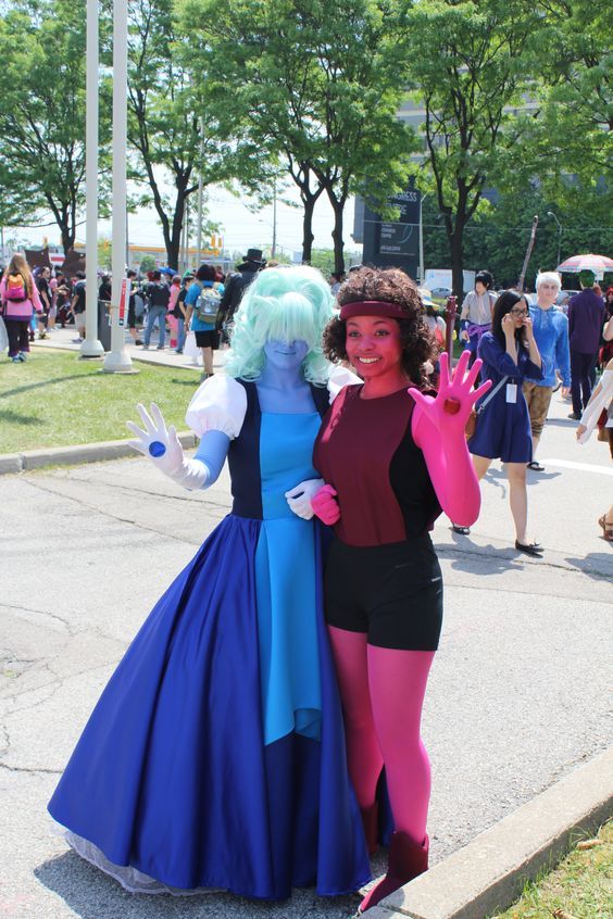 two women dressed in costumes posing for the camera