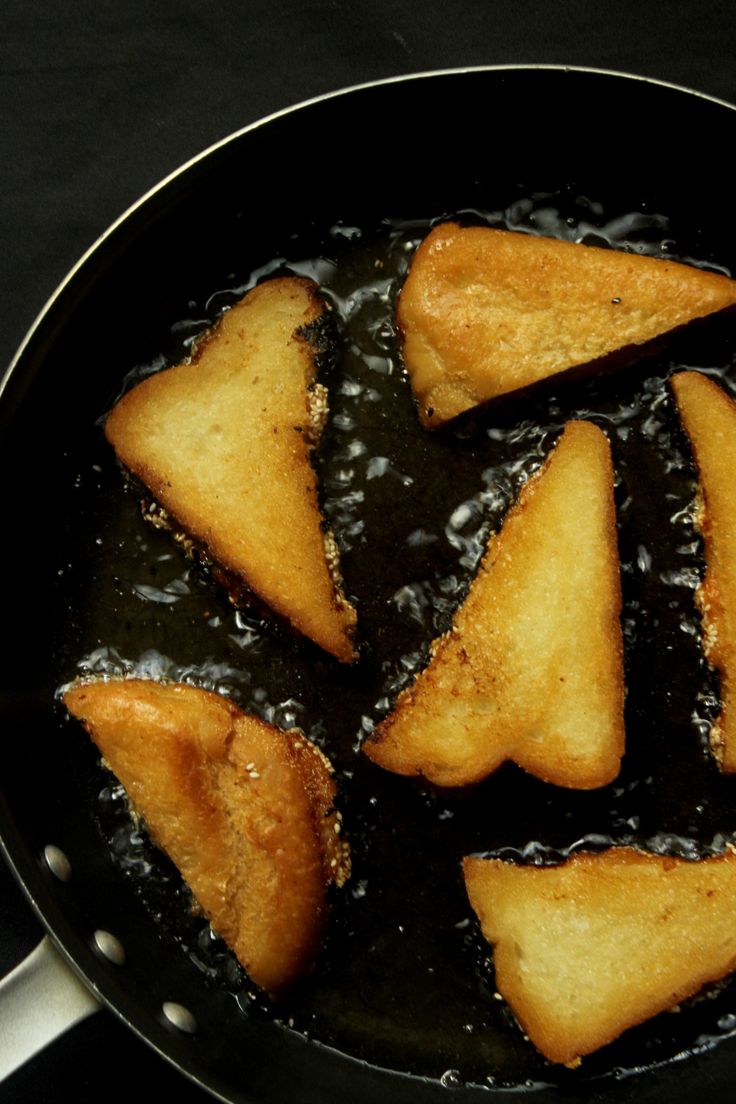 fried food cooking in a frying pan on the stove