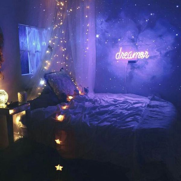 a bedroom decorated with lights and decorations