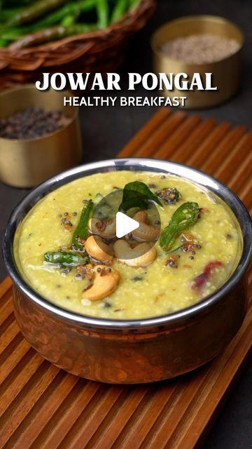 a bowl filled with food sitting on top of a wooden table next to green beans