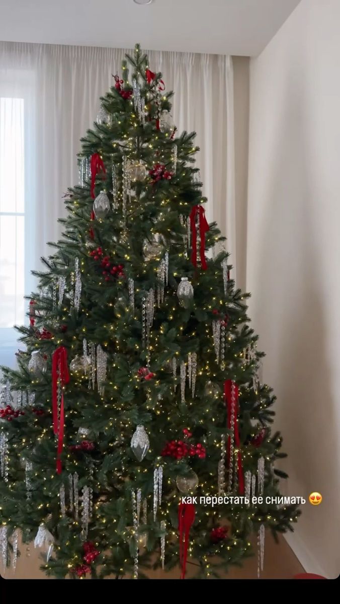 a decorated christmas tree with red and silver ornaments