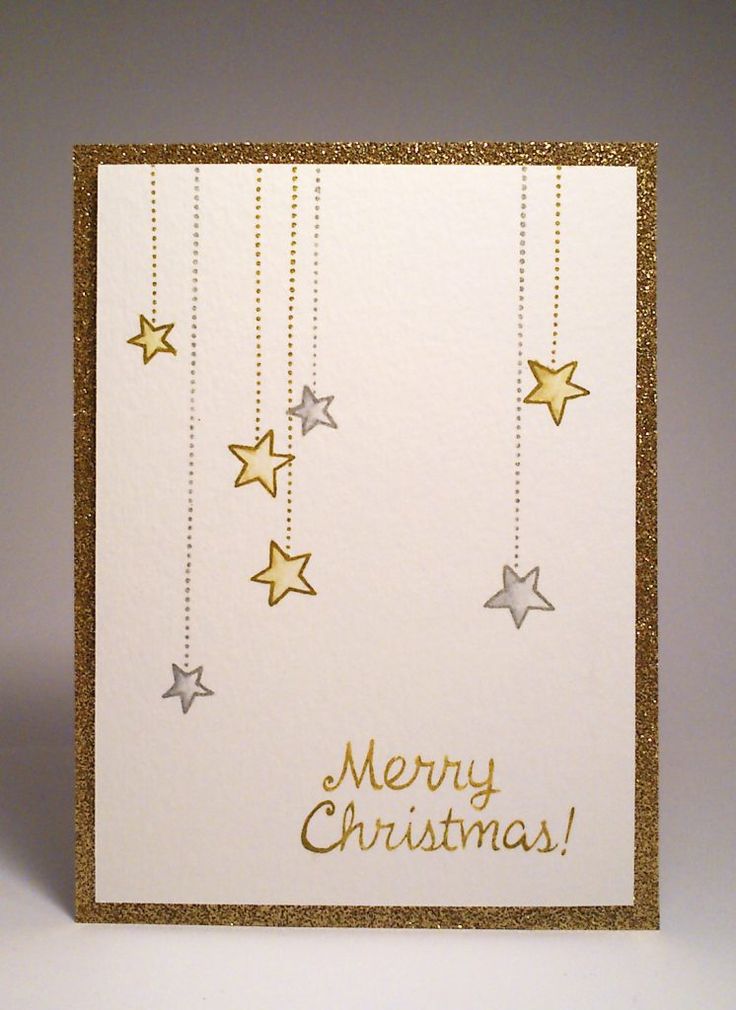 a white card with gold stars hanging from it's sides and merry christmas written on the front