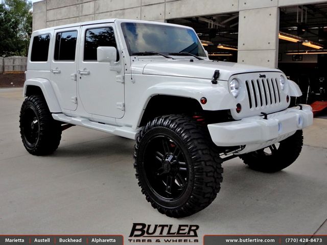 a white jeep parked in front of a building