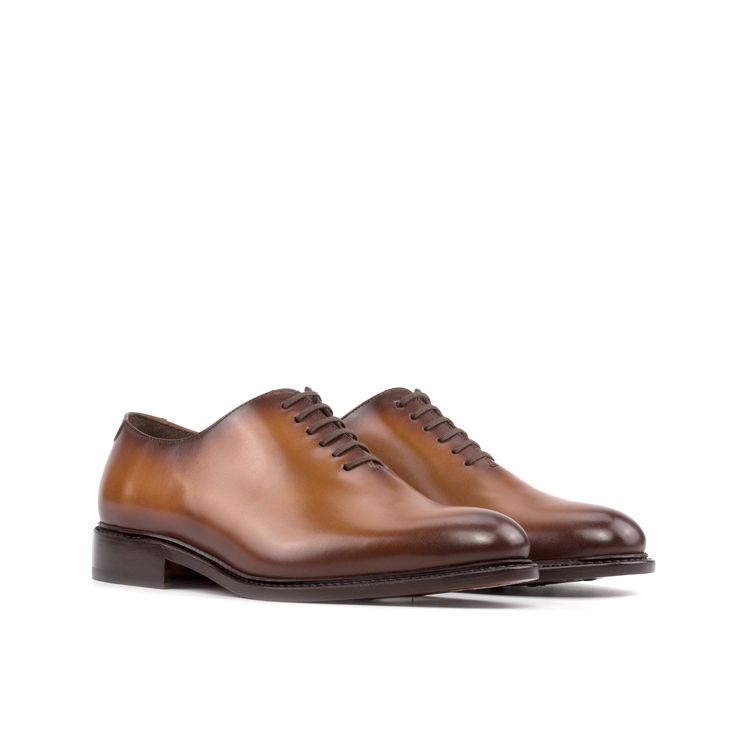 Often considered the most formal men's shoe available, the Wholecut features closed channel lacing and is made from a single cut of leather. The sleek design and limited stitching make for an elegant and highly sought-after style. The Details: Materials: cognac box calf Sole: cognac leather sole with rubber buttons injections Last: Zurigo - Rounded toe for traditional English Look What is Fast Lane? Fast lane is our new experimental 7 day made to order collection, an ambitious never been heard o Cognac Leather Shoes With Brogue Detailing For Semi-formal Occasions, Cognac Leather Cap Toe Shoes For Derby, Timeless Brown Lace-up Shoes With Leather Sole, Cognac Oxfords With Leather Sole For Derby, Cognac Oxfords With Brogue Detailing And Almond Toe, Cognac Oxfords With Leather Sole, Cognac Leather Shoes With Rubber Sole For Derby, Cognac Dress Shoes With Brogue Detailing, Cognac Dress Shoes With Brogue Detailing Almond Toe