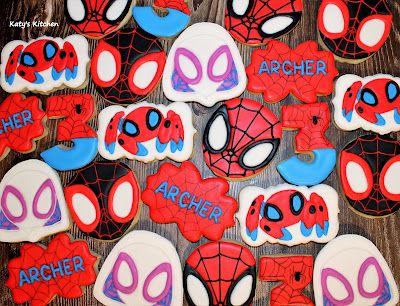 spiderman cookies are arranged on a table