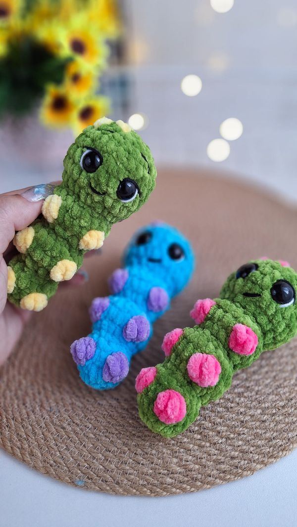 three small crocheted toy animals sitting on top of a table