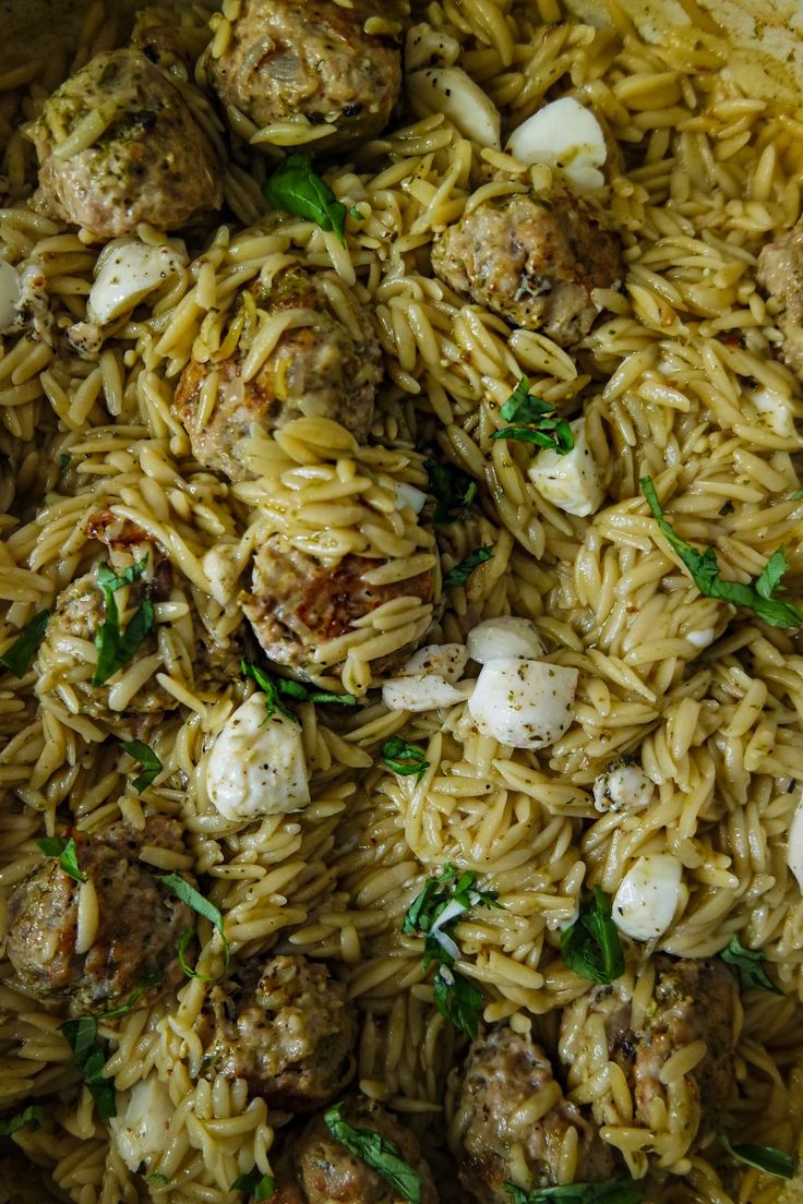 pasta with meatballs and onions in a pan