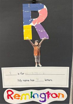 a child holding up a letter r on top of a blackboard with writing underneath it