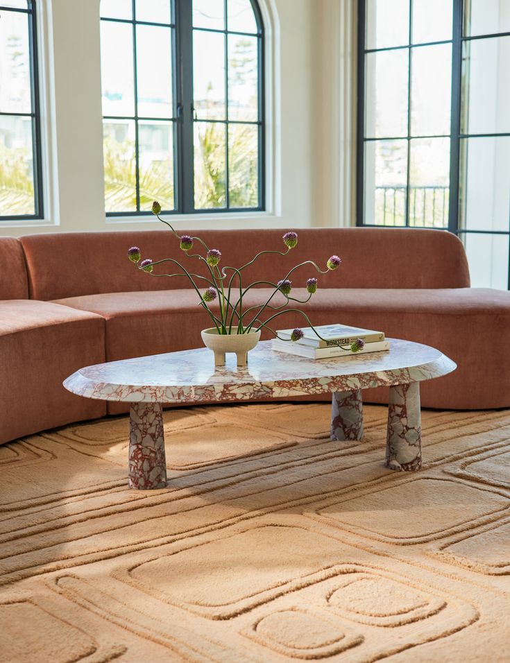 a living room with two couches and a coffee table in the middle of it