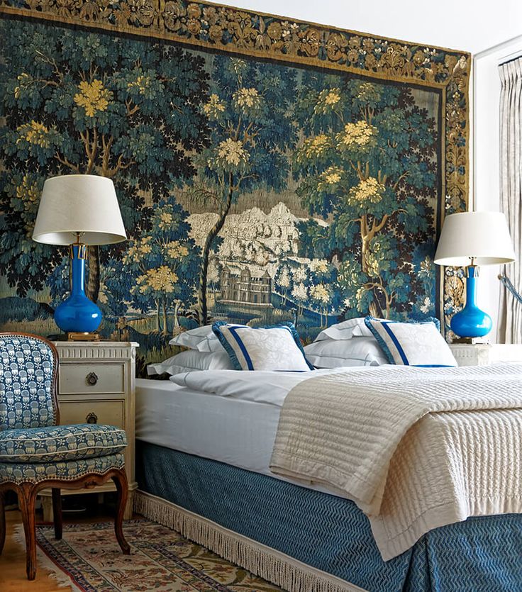 a bedroom with a large tapestry on the wall