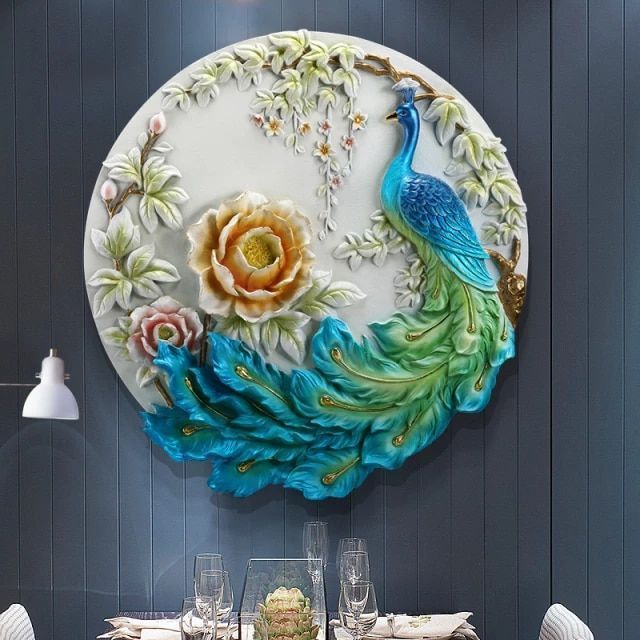 a decorative wall hanging above a dining room table with place settings and wine glasses on it