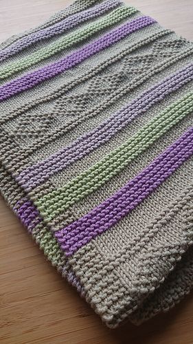 a crocheted blanket sitting on top of a wooden table