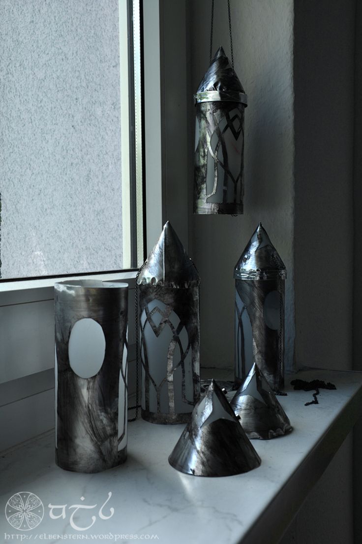 several silver objects sitting on top of a white counter next to a window sill