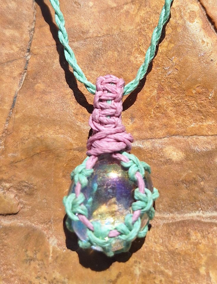 Iridescent glass on an adjustable cotton cord that may be worn long or short like a choker. The iridescence catches a rainbow array of colors. Adjustable Rainbow Crystal Bohemian Necklaces, Adjustable Rainbow Crystal Bohemian Necklace, Adjustable Cord Glass Jewelry, Adjustable Rainbow Bohemian Crystal Necklace, Adjustable Glass Jewelry With Cord, Adjustable Iridescent Necklace For Festivals, Iridescent Adjustable Necklace For Festivals, Adjustable Iridescent Glass Jewelry, Rainbow Adjustable Cord Jewelry For Festivals