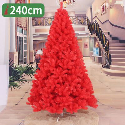 a red christmas tree in the middle of a hallway