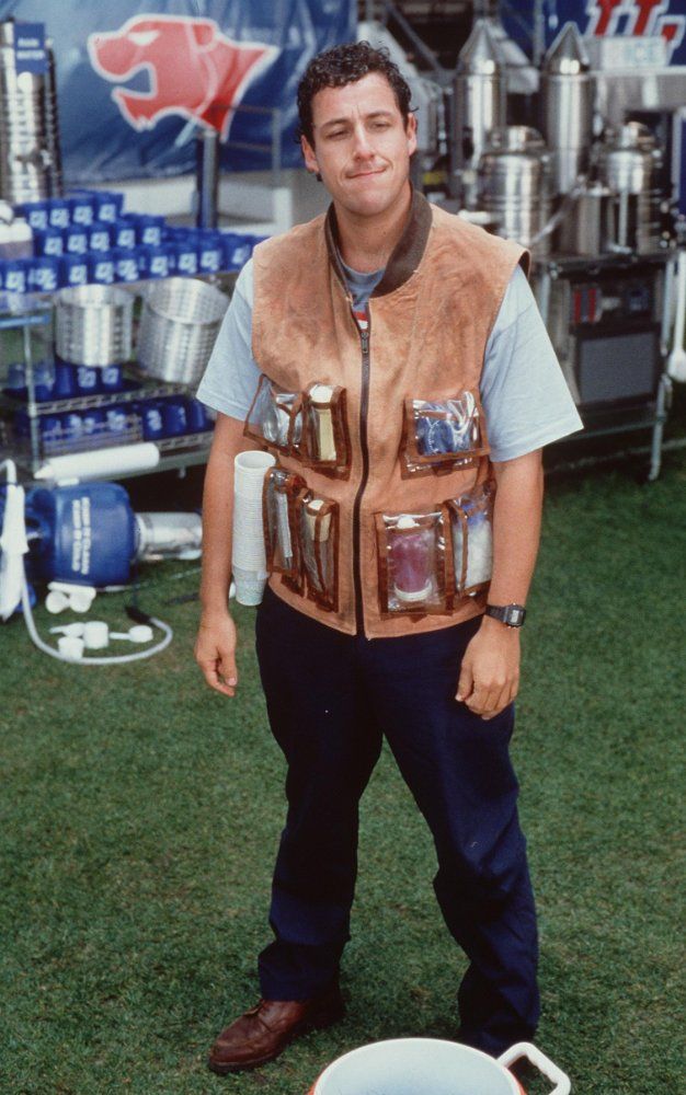 a man standing in the grass next to a white bowl and some beer kegs